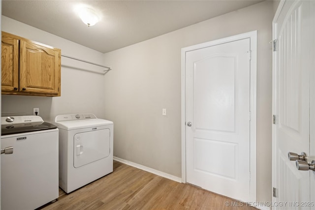 1600 S Ironwood Ave, Broken Arrow, OK 74012 - washroom with cabinet space, washer and dryer, and light wood-style flooring