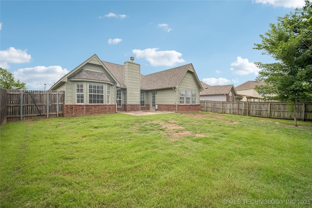 1600 S Ironwood Ave, Broken Arrow, OK 74012 - rear view of house featuring brick siding, a chimney, and a fenced backyard