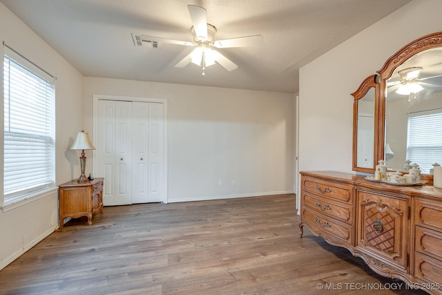 2520 Arlington Blvd, Ada, OK 74820 - bedroom featuring wood finished floors, a ceiling fan, and a closet