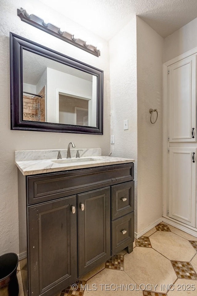 2520 Arlington Blvd, Ada, OK 74820 - bathroom featuring vanity, a textured ceiling, and a textured wall