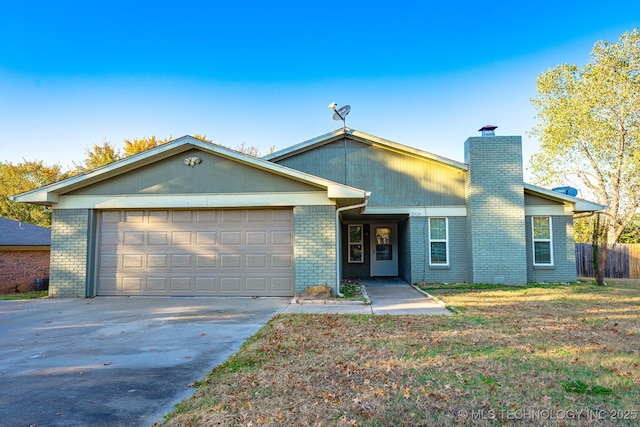 2520 Arlington Blvd, Ada, OK 74820 - view of front of house with a chimney, concrete driveway, and brick siding