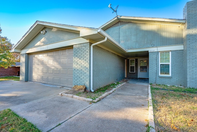 2520 Arlington Blvd, Ada, OK 74820 - view of front of property with brick siding, a garage, and concrete driveway
