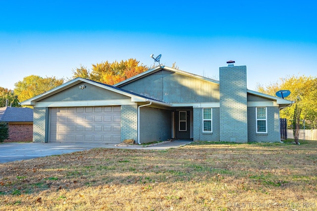 2520 Arlington Blvd, Ada, OK 74820 - view of front of home with an attached garage, a chimney, driveway, and brick siding