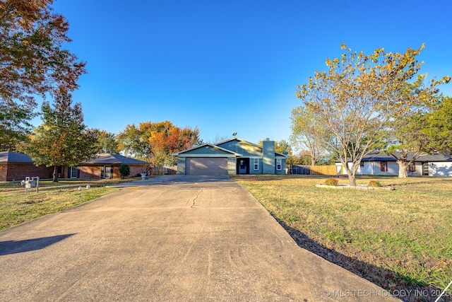 2520 Arlington Blvd, Ada, OK 74820 - ranch-style home with driveway, an attached garage, and a chimney