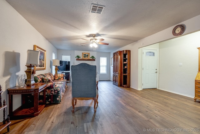 2520 Arlington Blvd, Ada, OK 74820 - living area with a ceiling fan, wood finished floors, and a textured ceiling