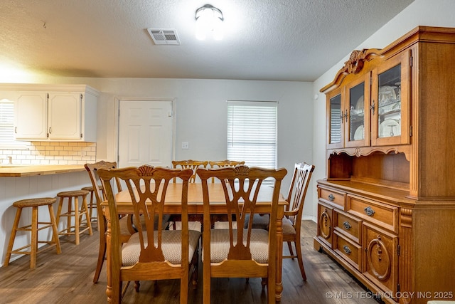 2520 Arlington Blvd, Ada, OK 74820 - dining space featuring dark wood-type flooring and a textured ceiling