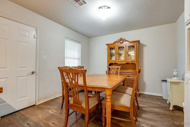 2520 Arlington Blvd, Ada, OK 74820 - dining space featuring wood finished floors and a textured ceiling