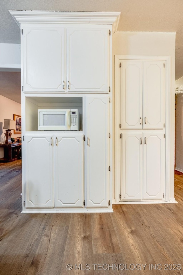 2520 Arlington Blvd, Ada, OK 74820 - detailed view of white microwave and wood finished floors