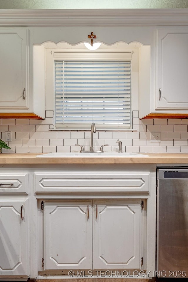 2520 Arlington Blvd, Ada, OK 74820 - kitchen featuring dishwasher, white cabinets, and tasteful backsplash