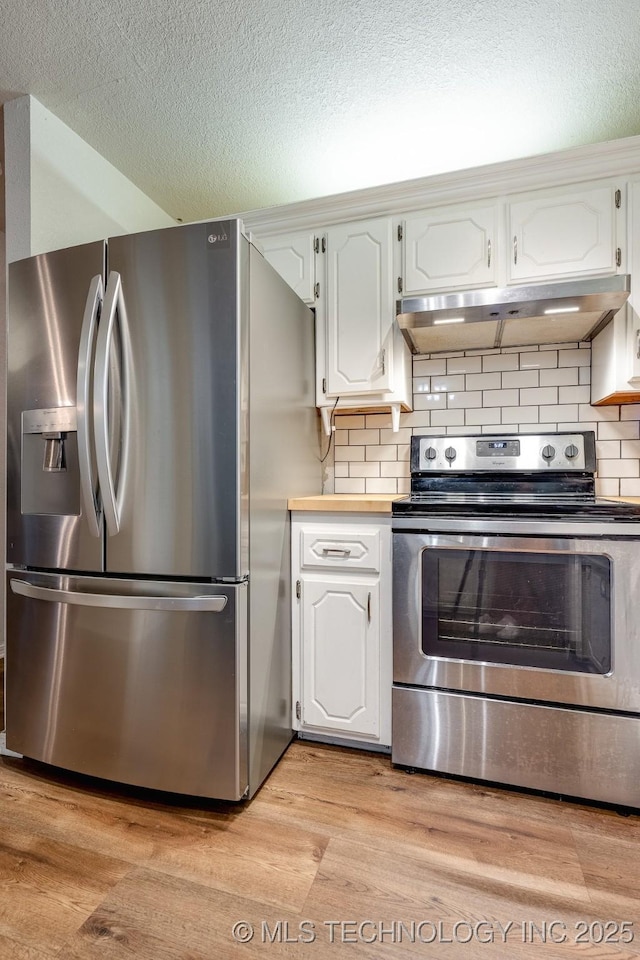 2520 Arlington Blvd, Ada, OK 74820 - kitchen featuring appliances with stainless steel finishes, under cabinet range hood, a textured ceiling, light wood finished floors, and backsplash