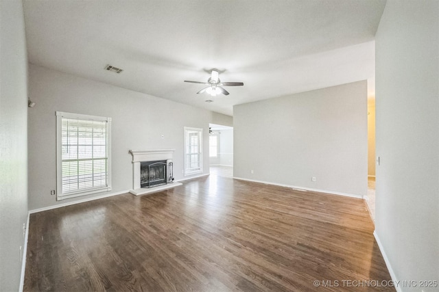12003 S Tamarack St W, Jenks, OK 74037 - unfurnished living room featuring ceiling fan, wood finished floors, and a fireplace with raised hearth