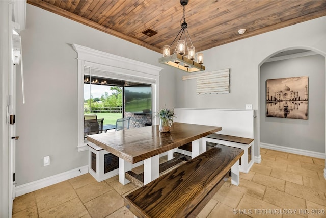 6108 E 95th St, Sperry, OK 74073 - dining space with stone tile flooring, wood ceiling, a chandelier, arched walkways, and crown molding