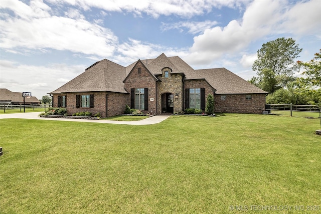 6108 E 95th St, Sperry, OK 74073 - french country home with brick siding and roof with shingles
