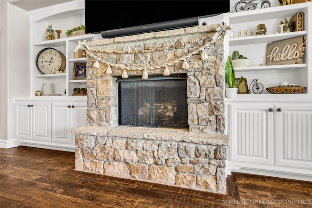 6108 E 95th St, Sperry, OK 74073 - living room with dark wood-type flooring, a stone fireplace, and built in features