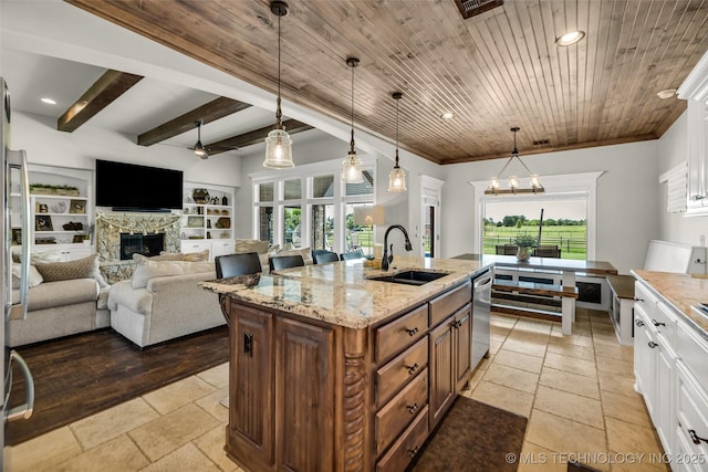 6108 E 95th St, Sperry, OK 74073 - kitchen featuring a fireplace, stone tile floors, white cabinets, pendant lighting, and recessed lighting