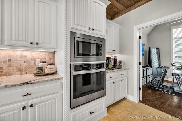 6108 E 95th St, Sperry, OK 74073 - kitchen featuring appliances with stainless steel finishes, wood ceiling, backsplash, light stone countertops, and white cabinets