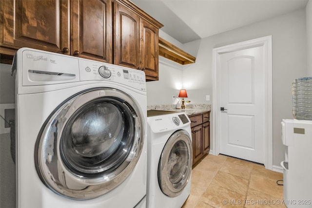 6108 E 95th St, Sperry, OK 74073 - washroom featuring independent washer and dryer, cabinet space, and light stone finish floors