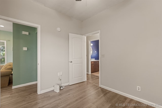 108 W 135th St, Skiatook, OK 74070 - unfurnished bedroom with wood finished floors and baseboards
