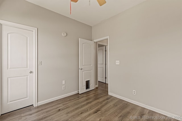 108 W 135th St, Skiatook, OK 74070 - unfurnished bedroom with wood finished floors and ceiling fan