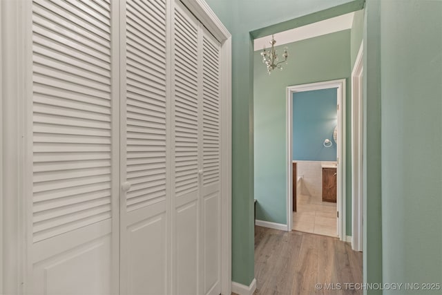 108 W 135th St, Skiatook, OK 74070 - corridor with a chandelier and light wood-style flooring