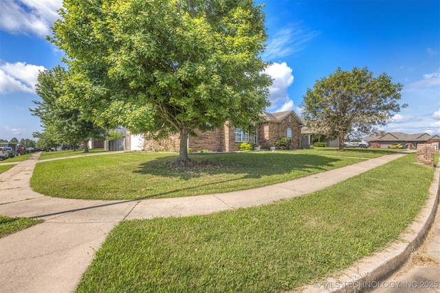 108 W 135th St, Skiatook, OK 74070 - obstructed view of property featuring a front yard and brick siding