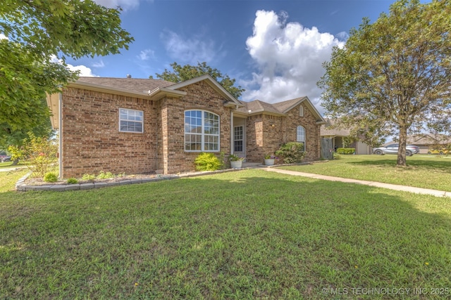 108 W 135th St, Skiatook, OK 74070 - view of front of property with a front yard, brick siding, and roof with shingles