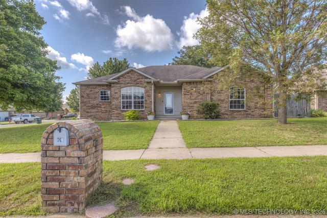 108 W 135th St, Skiatook, OK 74070 - view of front of house featuring a front lawn, a shingled roof, and brick siding