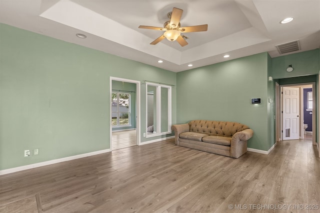 108 W 135th St, Skiatook, OK 74070 - living area with a raised ceiling, ceiling fan, wood finished floors, and recessed lighting
