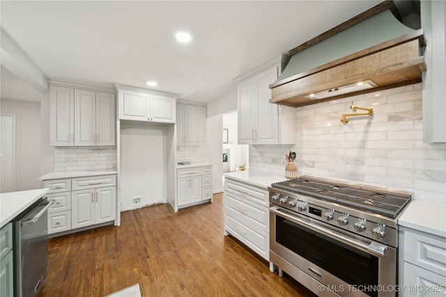 3919 S Detroit Ave, Tulsa, OK 74105 - kitchen featuring stainless steel appliances, custom exhaust hood, light countertops, tasteful backsplash, and white cabinets