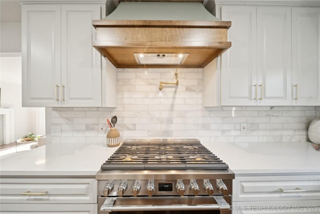 3919 S Detroit Ave, Tulsa, OK 74105 - kitchen featuring high end range, custom exhaust hood, white cabinetry, light countertops, and decorative backsplash