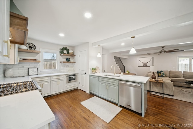 3919 S Detroit Ave, Tulsa, OK 74105 - kitchen with stainless steel dishwasher, open shelves, backsplash, dark wood-style floors, and recessed lighting