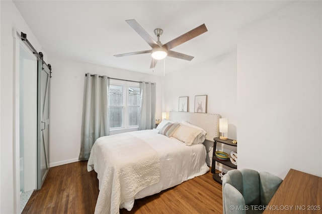 3919 S Detroit Ave, Tulsa, OK 74105 - bedroom featuring a barn door, wood finished floors, and a ceiling fan