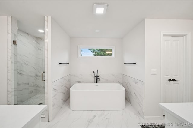 3919 S Detroit Ave, Tulsa, OK 74105 - full bathroom featuring marble finish floors, a marble finish shower, a freestanding bath, vanity, and tile walls