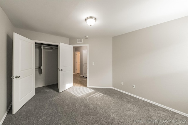 17409 E 44th St S, Tulsa, OK 74134 - unfurnished bedroom with dark carpet and a closet