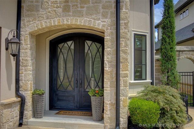 4401 S Yellow Pine Ave, Broken Arrow, OK 74011 - doorway to property with french doors and stone siding