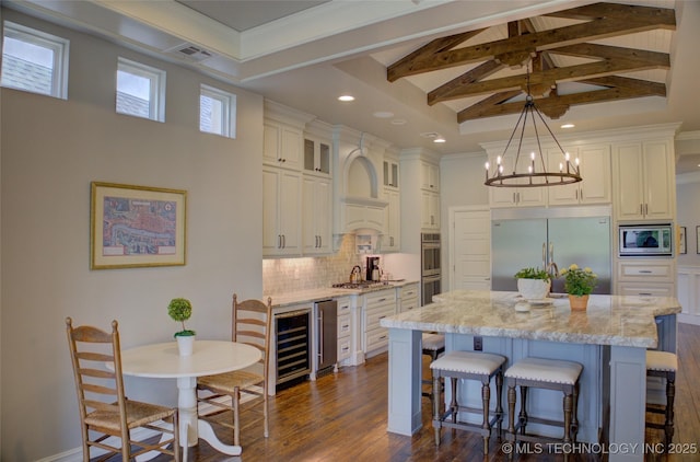 4401 S Yellow Pine Ave, Broken Arrow, OK 74011 - kitchen featuring built in appliances, high vaulted ceiling, a breakfast bar area, a kitchen island, and beamed ceiling