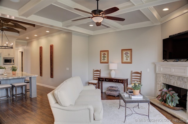 4401 S Yellow Pine Ave, Broken Arrow, OK 74011 - living area featuring coffered ceiling, a ceiling fan, beam ceiling, dark wood finished floors, and a stone fireplace