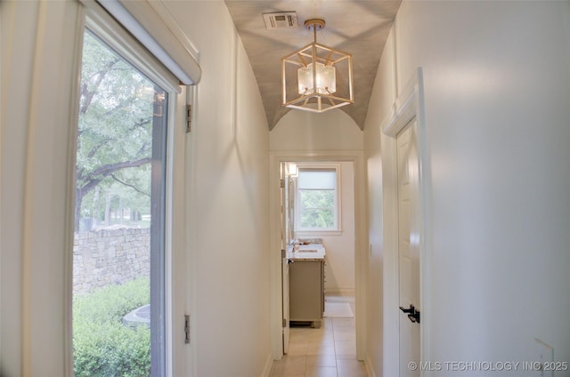 4401 S Yellow Pine Ave, Broken Arrow, OK 74011 - hallway featuring a chandelier, lofted ceiling, and light tile patterned flooring