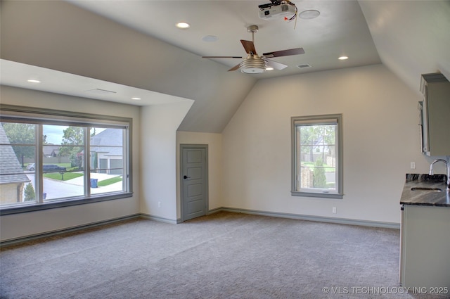 4401 S Yellow Pine Ave, Broken Arrow, OK 74011 - unfurnished living room featuring light colored carpet, vaulted ceiling, healthy amount of natural light, ceiling fan, and recessed lighting