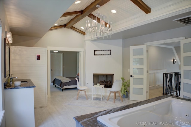 4401 S Yellow Pine Ave, Broken Arrow, OK 74011 - ensuite bathroom featuring a tub with jets, vanity, a chandelier, recessed lighting, and wood finished floors