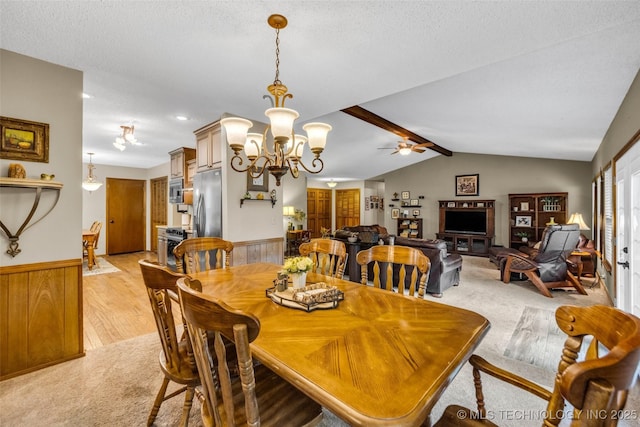 9601 Spring Lake Dr, Broken Arrow, OK 74014 - dining room featuring a wainscoted wall, a chandelier, ceiling fan, light wood finished floors, and a textured ceiling