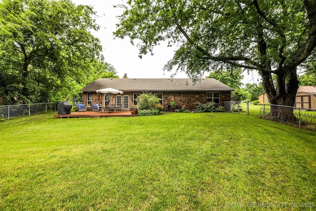 9601 Spring Lake Dr, Broken Arrow, OK 74014 - rear view of house featuring a fenced backyard, a deck, a chimney, and stone siding