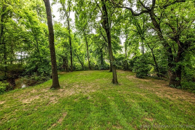 9601 Spring Lake Dr, Broken Arrow, OK 74014 - view of green lawn with a forest view