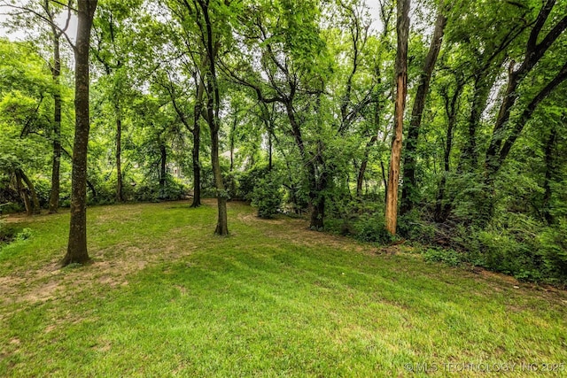 9601 Spring Lake Dr, Broken Arrow, OK 74014 - view of green lawn featuring a wooded view