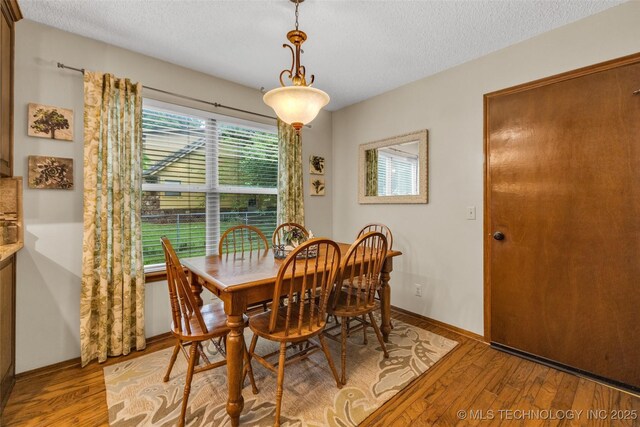 9601 Spring Lake Dr, Broken Arrow, OK 74014 - dining space featuring a textured ceiling and light wood finished floors
