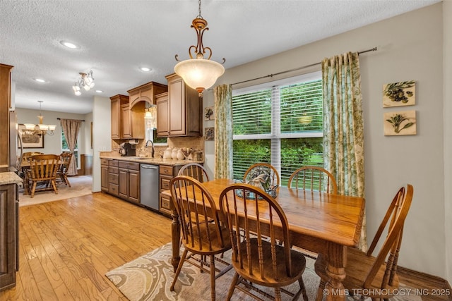9601 Spring Lake Dr, Broken Arrow, OK 74014 - dining space with a textured ceiling, light wood-style floors, a chandelier, and recessed lighting