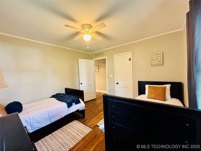 401 High St, Eufaula, OK 74432 - bedroom with ornamental molding, wood finished floors, and a ceiling fan