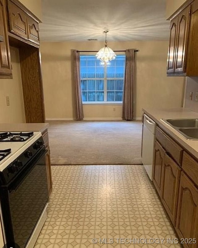 9375 E 530th Rd, Claremore, OK 74019 - kitchen featuring range with gas stovetop, white dishwasher, a chandelier, light countertops, and decorative light fixtures