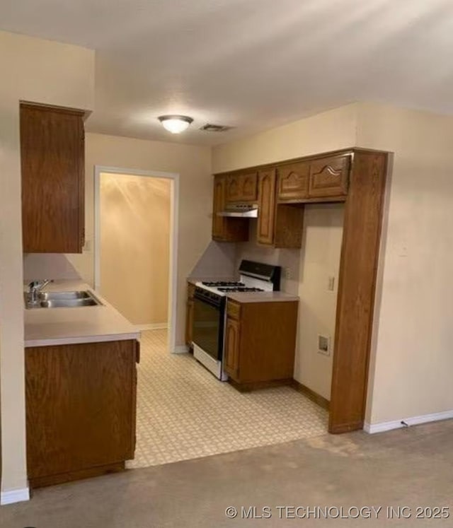 9375 E 530th Rd, Claremore, OK 74019 - kitchen featuring range with gas stovetop, light countertops, and under cabinet range hood