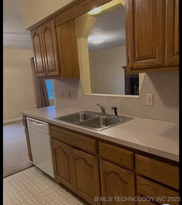 9375 E 530th Rd, Claremore, OK 74019 - kitchen featuring white dishwasher, light countertops, light flooring, and brown cabinetry